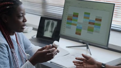 Médico que receta píldoras a un hombre y habla sobre el tratamiento en la clínica