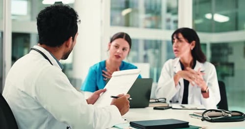 Medical Professionals in Meeting Discussing Patient Data