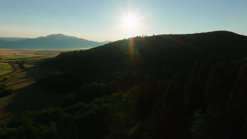 Soaring Over Forests And Mountain Valley In Rising Morning Sunlight Aerial View