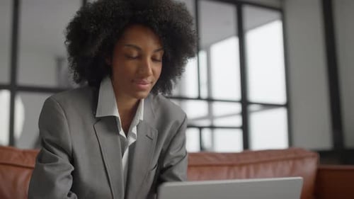 Focused Businesswoman Working on Laptop at Office