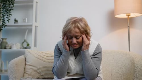 Senior Woman Experiencing Headache Pain at Home