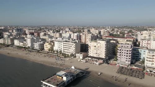 Restaurant pier flyover: Quiet sandy beach in coastal Durres, Albania