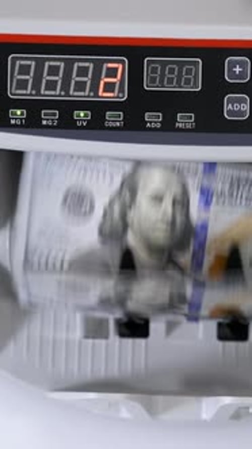 Currency Counter Counting Stack of One Hundred Dollar Bills