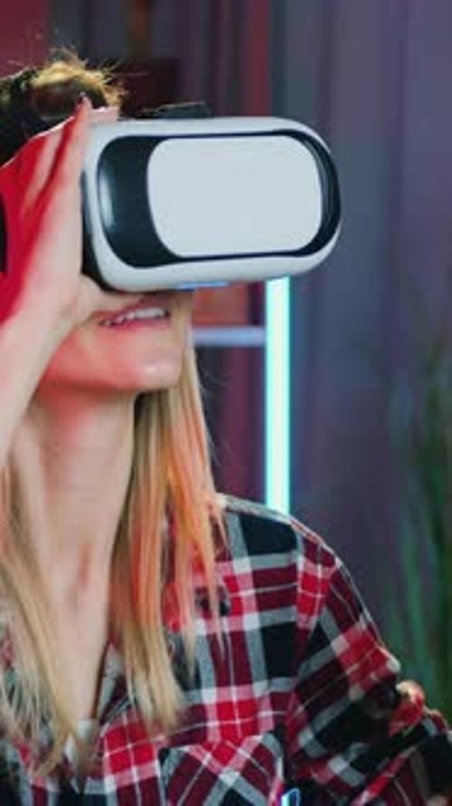 Woman Wearing VR Headset Interacts with Virtual Reality