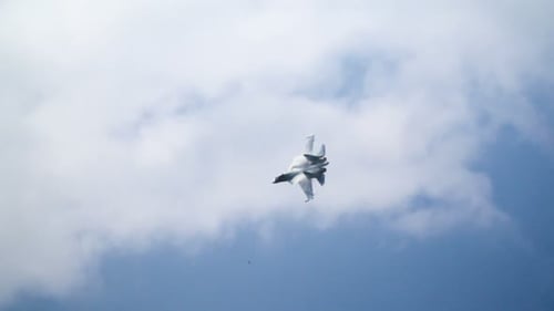 Fighter Jet Flying Against Cloudscape