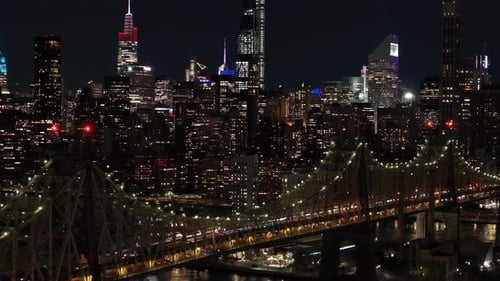 Aerial Views Capture New York City Skyline at Night Showcasing Queensboro Bridge and Sparkling East