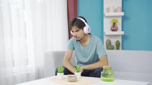 Man Listens With Headphones Looking Out Window