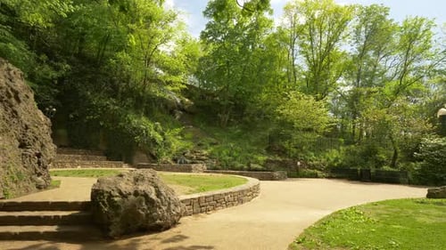 Slow motion rock path through lush greenery in beautiful midwestern park