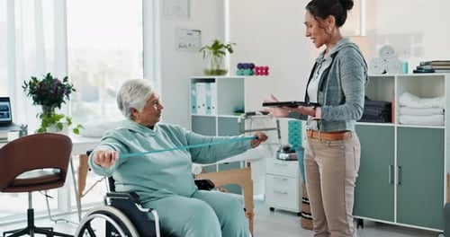 Senior Woman Exercising with Resistance Band in Physical Therapy