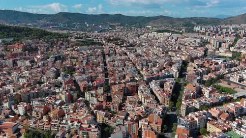 Barcelona city skyline, aerial view of Horta Guinardo and Nou Barris districts during a sunny day