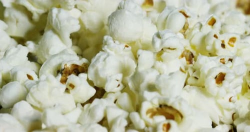 macro shot of a popcorn texture of salted and unsalted corn. I will eat popcorn at the movies duri