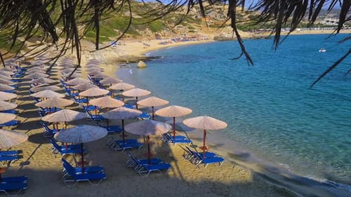 Empty Beach on Mediterranean Sea, Sunshades and Parasols on Sunny Morning