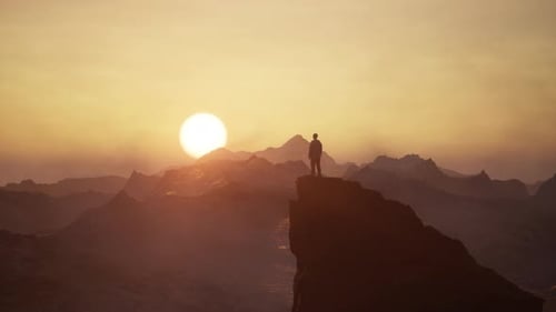Adventure Man Looking at Rocky Mountain Landscape