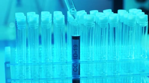 Covid Test Liquid Being Dripped into Test Tube