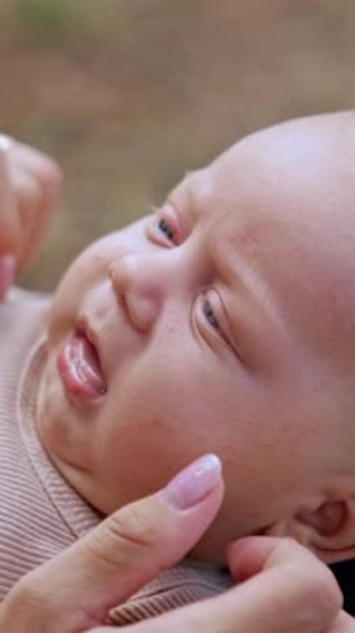 Cute Baby with Blue Eyes Being Soothed