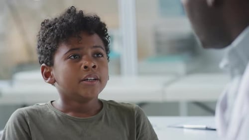 Kid Talking with Doctor in Pediatric Clinic