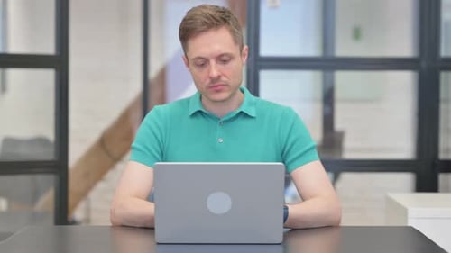 Man working at laptop computer in office