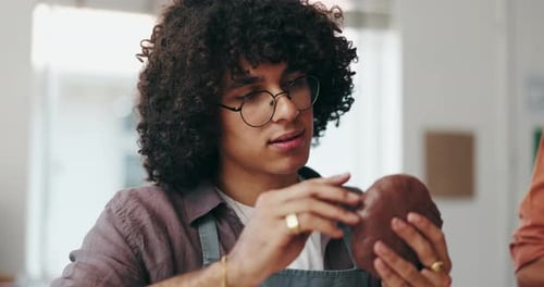 Young Adult Smoothing Clay in Bright Workshop