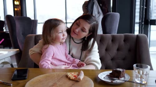 Mother and Child Dining at Restaurant Table