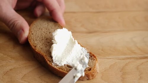 Spreading Cream Cheese on Bread Slice