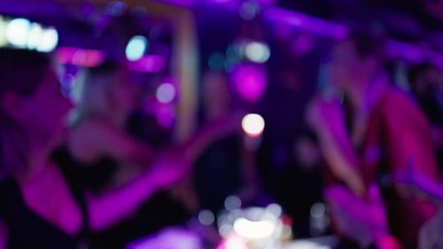 Blurred Nightclub Scene with People Dancing and Enjoying