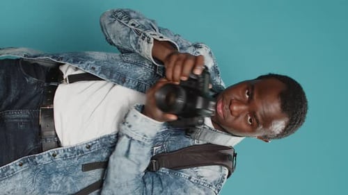 Young Adult Using a Digital Camera in Studio