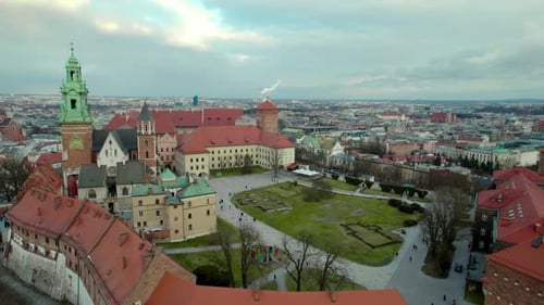 Aerial backwards drone dolly over Krakow Wawel Royal Castle and Vistula river, city center fortress