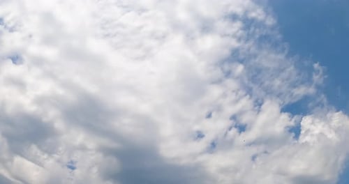 White clouds covering the sky quickly. Blue horizon clears up. Low angle view. Timelapse.