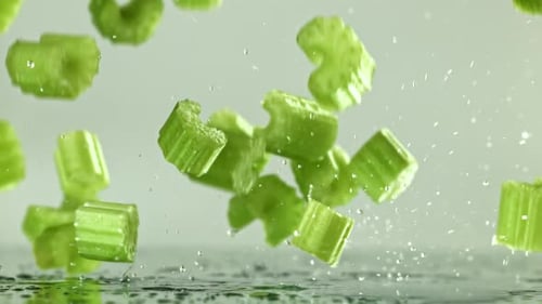 Sliced Pieces of Fresh Celery Fall on the Table Filmed on a Highspeed Camera at 1000 Fps