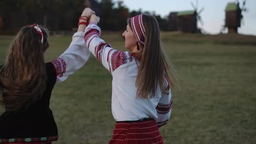 Women Dancing in Traditional Clothing Outdoors
