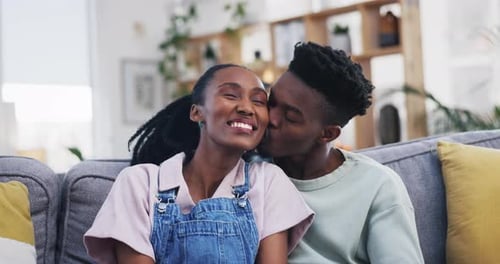 Affectionate Couple Smiling and Embracing on Couch