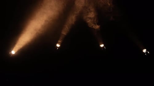Bright Spotlights Beam From Professional Lighting Equipment Sparkle in the Dark with Floating Smoke
