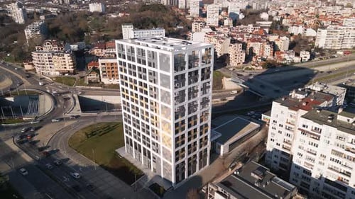 Modern Architectural Design Showcased in Urban Landscape with Surrounding Buildings and Busy Roads
