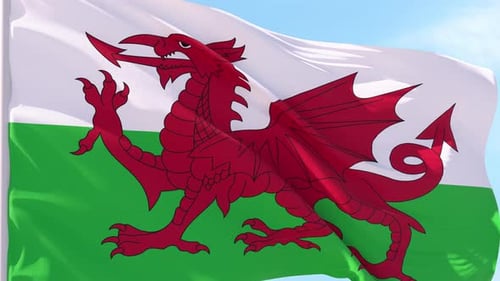 Realistic Waving Flag of Wales Against Clear Blue Sky