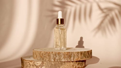 Podium for Presentation of a Cosmetic Product on Pastel Beige Background in the Morning Rays of