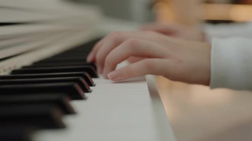 Child's Hands Play Piano Close-up