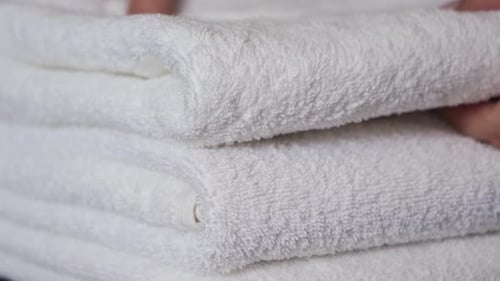 Freshly Laundered Soft White Towels Folded Neatly in Home