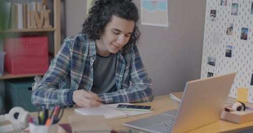 Student Studying at Desk with Laptop