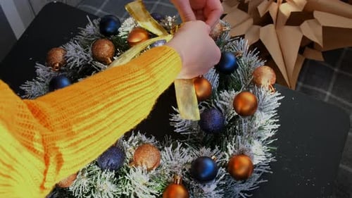 Woman Tying Decorative Ribbon DIY Process of Woman Making Christmas Arrangement with Decor of Blue