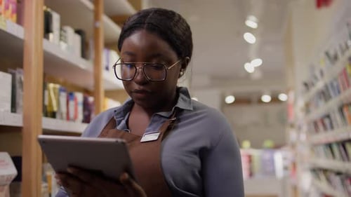 Beauty Store Manager with Tablet Doing Inventory of Skincare Goods