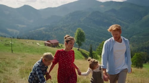 Positive Family Fooling on Nature Coming on Top Green Hill. Joyful Couple