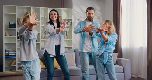 Happy Family Dancing Together in Living Room