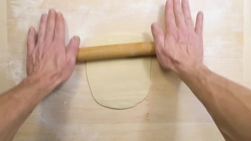 Dough Being Rolled Out with Rolling Pin