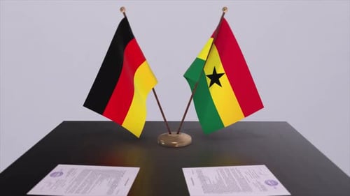 Ghana and Germany Flags on Table with Contracts