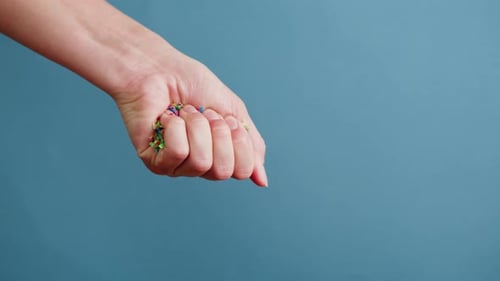 Hand Opens, Colorful Plastic Falls