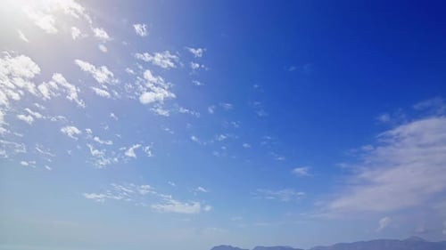 Clouds Moving Across a Bright Blue Sky