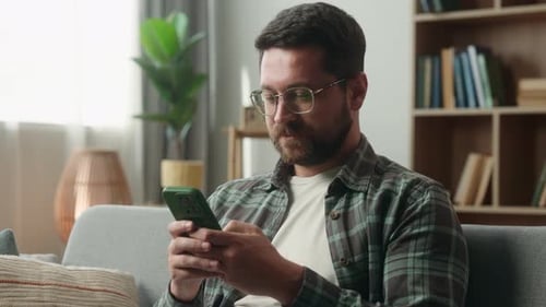 Caucasian Man Smiling Showing Green Screen Smartphone at Home Thumb Up Recommend Male Guy Display