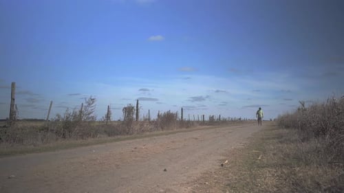 A man walking in a rural area.