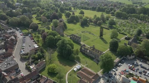 Aerial view of the Glastonbury Abbey ruins an 8th century monastery and gardens. Drone rotating to t