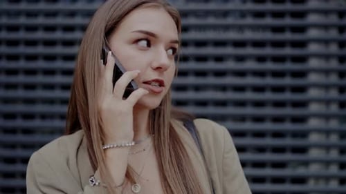 Woman Chatting on Smartphone in Urban Setting